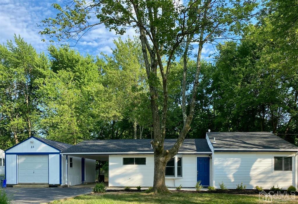 23 Springdale Road Kendall Park, NJ 08824 - Photo 1 of 26 a front view of house with yard and trees in the background