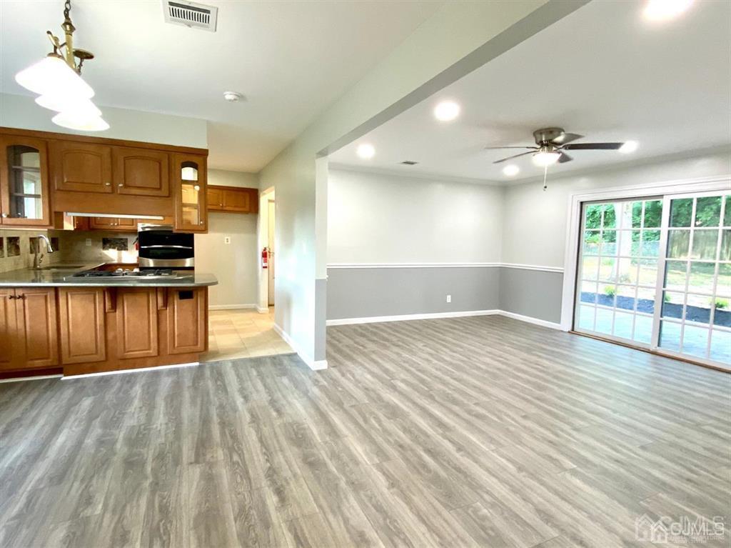 23 Springdale Road Kendall Park, NJ 08824 - Photo 2 of 26 a view of a kitchen with wooden floor and a kitchen space