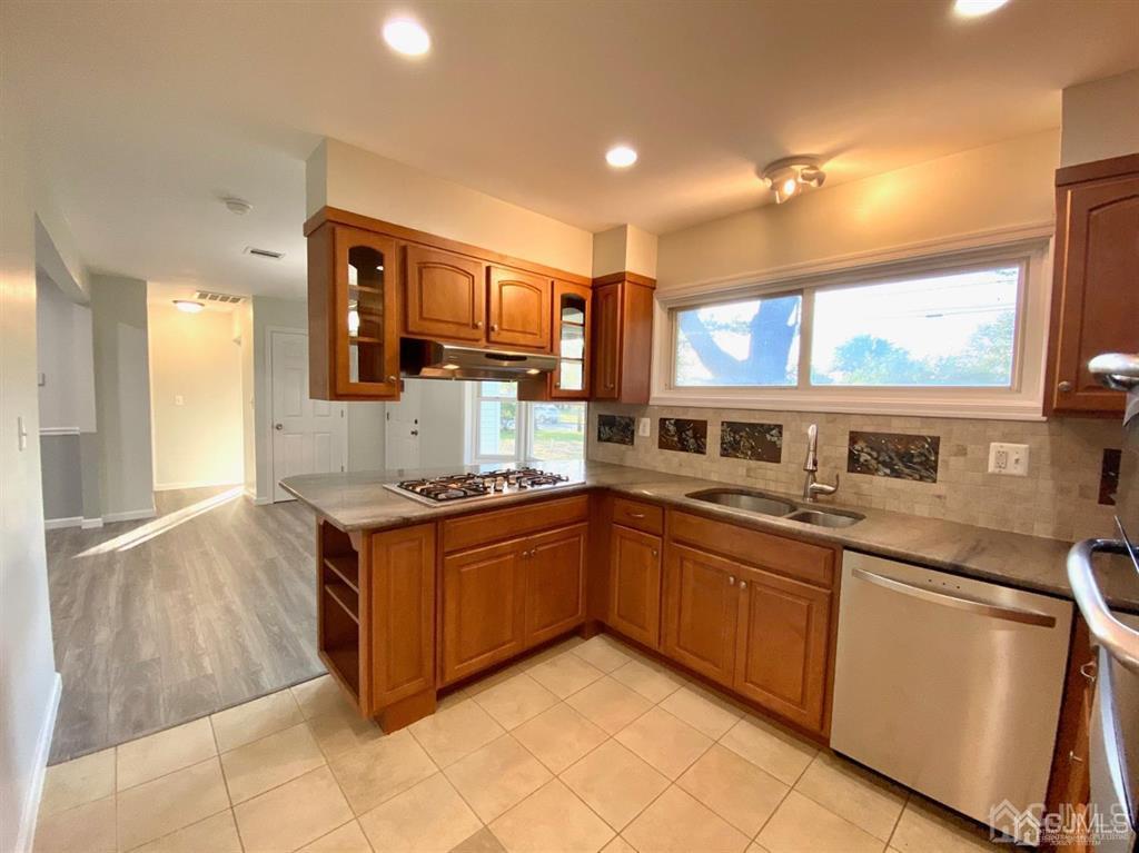 23 Springdale Road Kendall Park, NJ 08824 - Photo 8 of 26 a kitchen with stainless steel appliances granite countertop a stove a sink and a microwave
