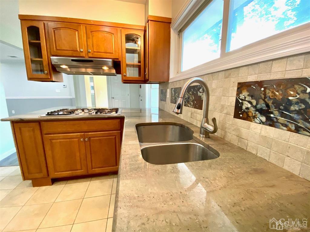 23 Springdale Road Kendall Park, NJ 08824 - Photo 9 of 26 a kitchen with stainless steel appliances granite countertop a sink stove and cabinets