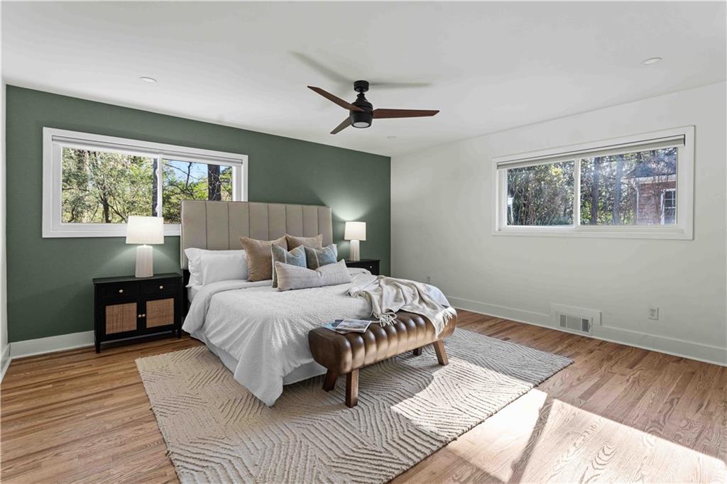 2576 River Oak Drive Decatur, GA 30033 - Photo 15 of 47 a bedroom with a large bed chandelier and a window