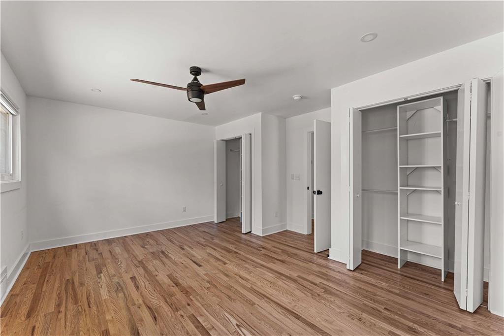 2576 River Oak Drive Decatur, GA 30033 - Photo 24 of 47 a view of a room with wooden floor staircase and a ceiling fan