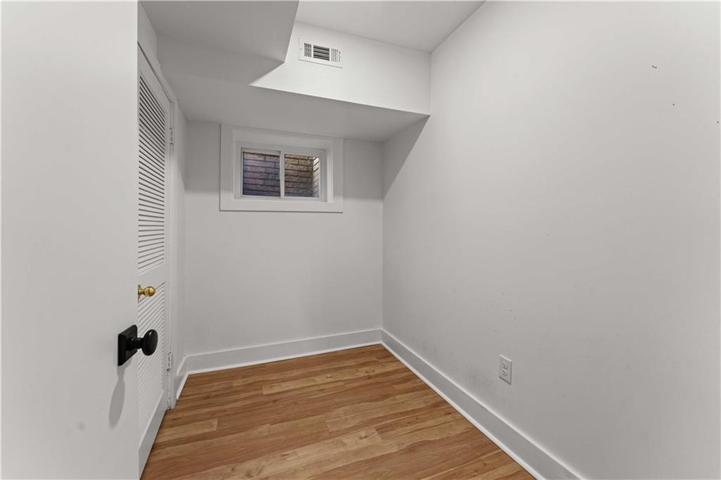 2576 River Oak Drive Decatur, GA 30033 - Photo 39 of 47 a view of a room with wooden floor and a ceiling fan