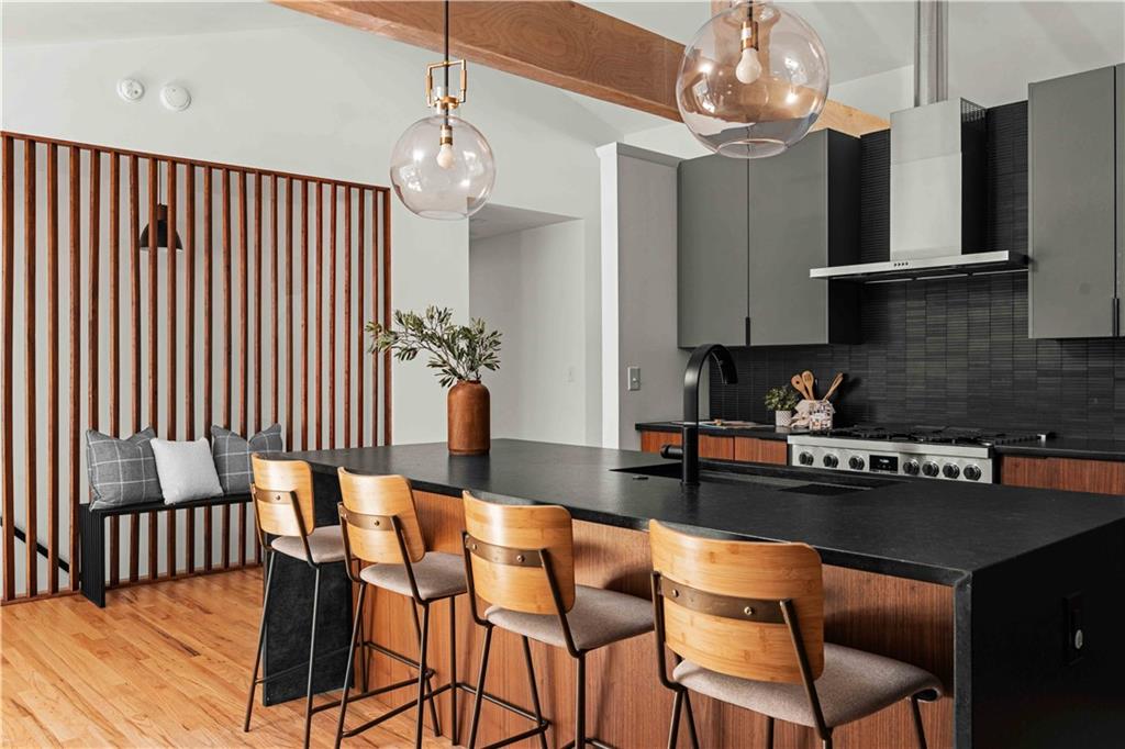 2576 River Oak Drive Decatur, GA 30033 - Photo 6 of 47 a kitchen with stainless steel appliances granite countertop a stove top oven a refrigerator a sink and a dining table with wooden floor