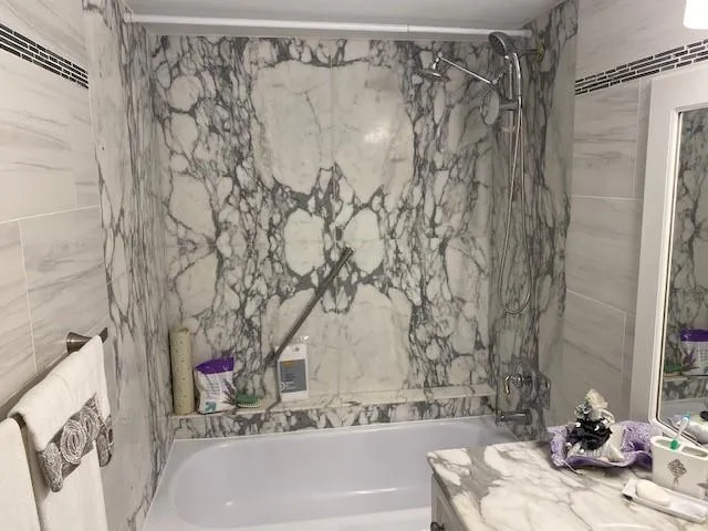 a bathroom with a bathtub and shower