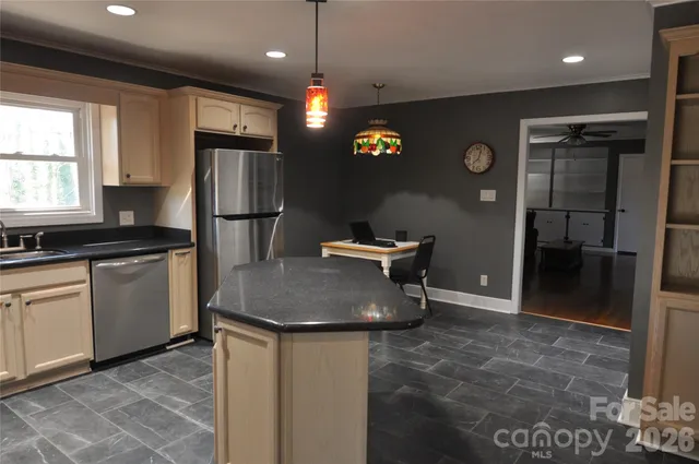 a kitchen with refrigerator and window