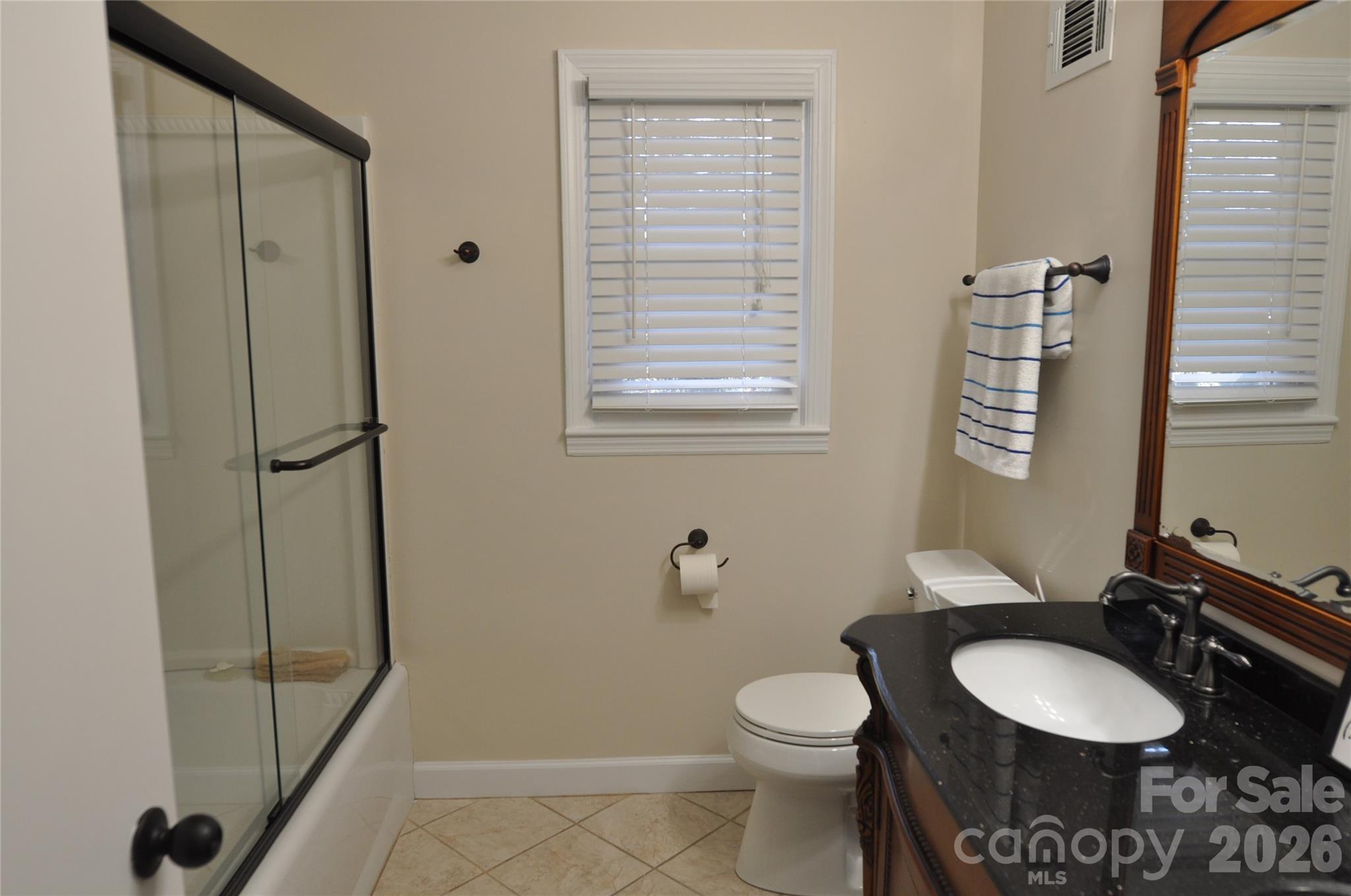 109 Shamrock Drive Chester, SC 29706 - Photo 22 of 38 a bathroom with a toilet a sink a mirror and shower