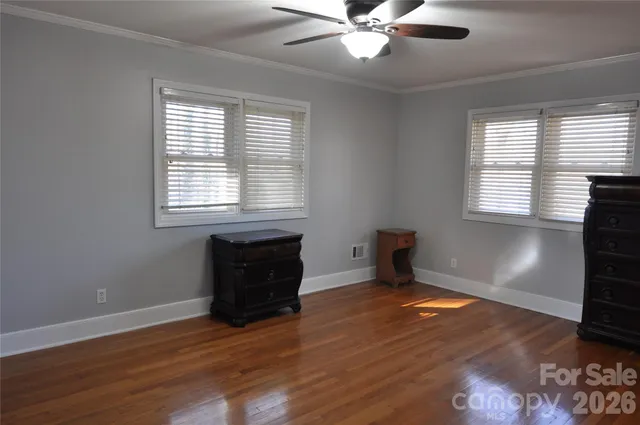 a living room with hard wood floors and a window
