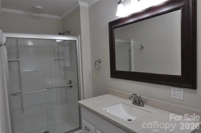 a bathroom with a sink vanity and mirror