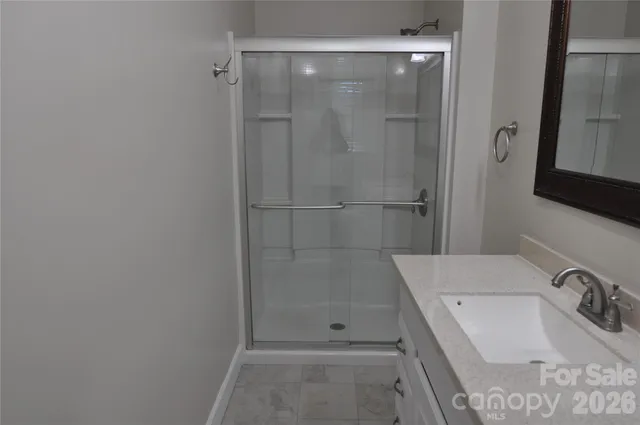 a bathroom with a tub sink and shower