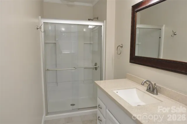 a bathroom with a granite countertop sink mirror and shower