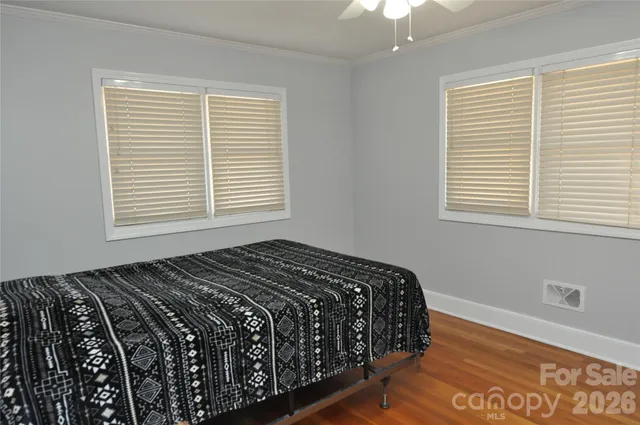 a bedroom with a bed next to a window