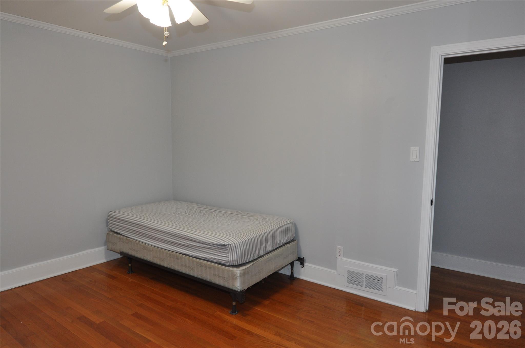 109 Shamrock Drive Chester, SC 29706 - Photo 32 of 38 a room with a bed and a chandelier fan