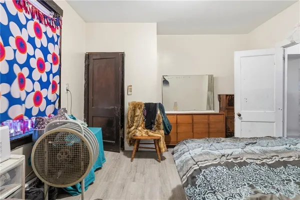 a bedroom with a bed and chair
