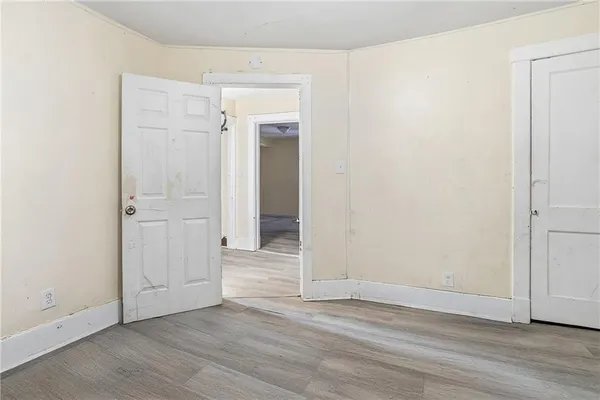 an empty room with wooden floor