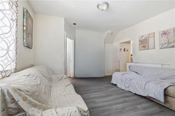 a bedroom with a bed and a painting on the wall