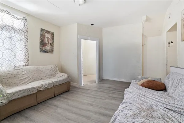 a bedroom with a bed and a painting on the wall