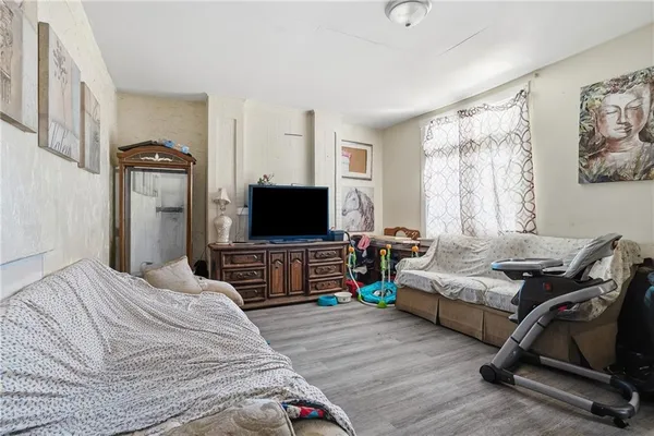 a bedroom with furniture and a flat screen tv