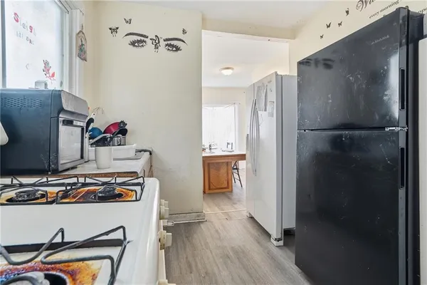 a kitchen with refrigerator and window