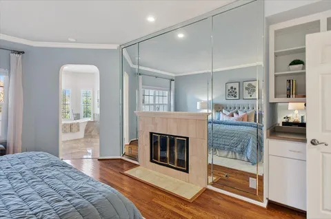 a bedroom with a bed and a fireplace