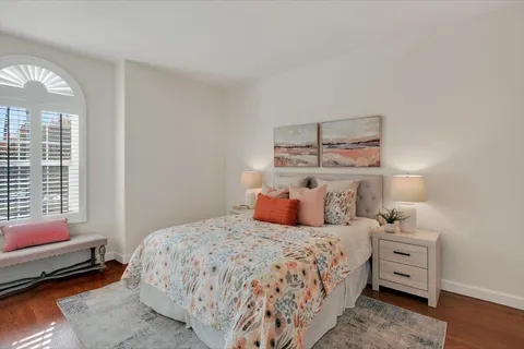 a bedroom with a bed and wooden floor