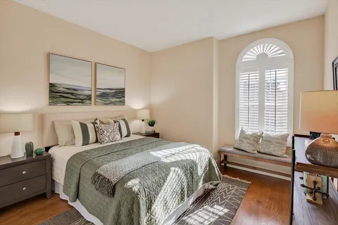 a bedroom with a bed and a window