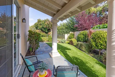 a view of yard with patio