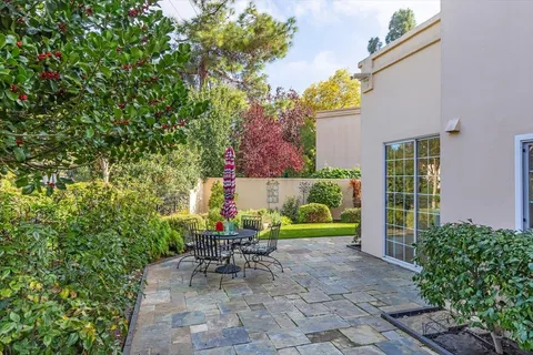 a view of a chairs and table in backyard of the house