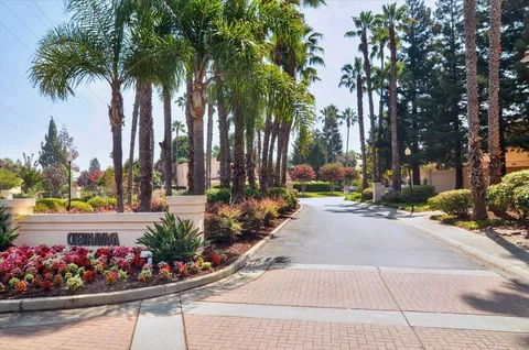 a view of a flower in a garden with a building