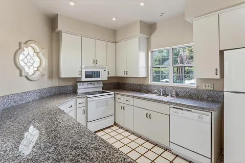 a kitchen with appliances cabinets and a sink