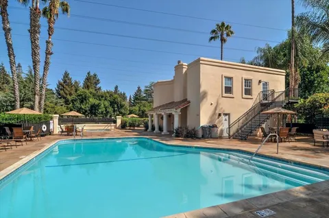 a view of a house with swimming pool and sitting area