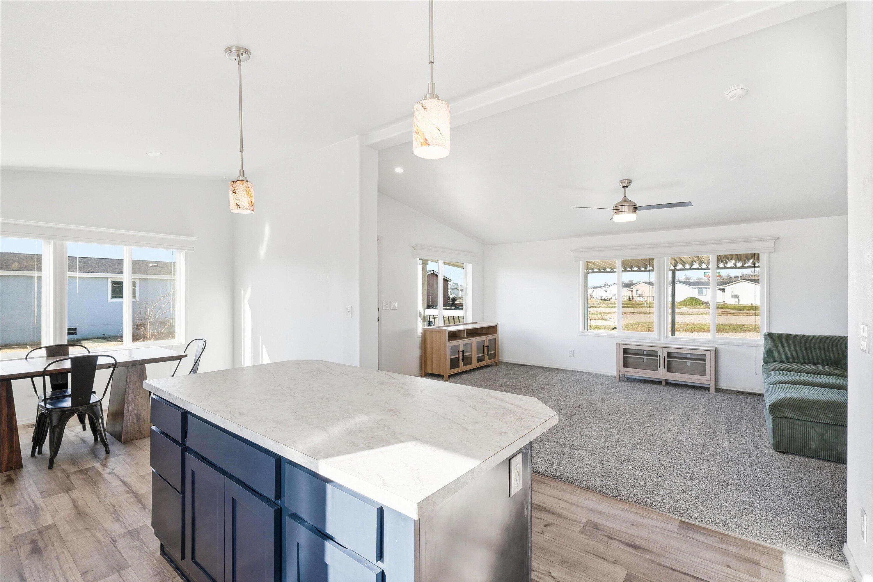 300 Luman Road, Unit 197 Phoenix, OR 97535 - Photo 10 of 26 a open kitchen with stainless steel appliances granite countertop a stove a refrigerator a sink a dining table and chairs with wooden floor