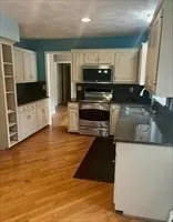a kitchen with a stove and a microwave