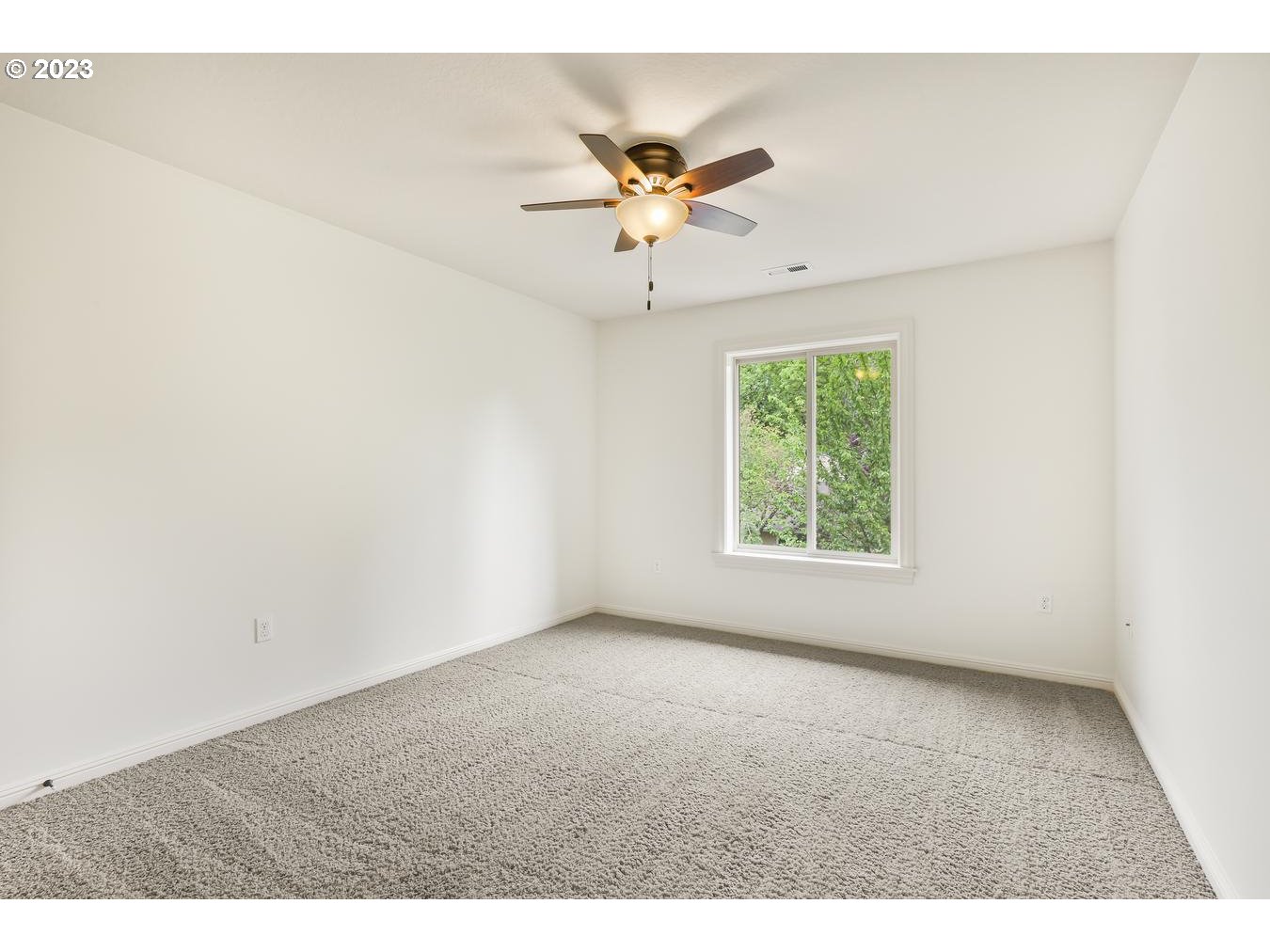 9277 Southwest Rambler Lane Portland, OR 97223 - Photo 17 of 38 an empty room with windows and ceiling fan