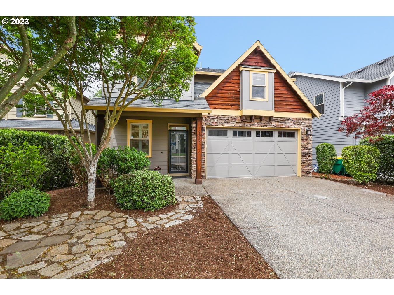 9277 Southwest Rambler Lane Portland, OR 97223 - Photo 2 of 38 a front view of a house with a garden