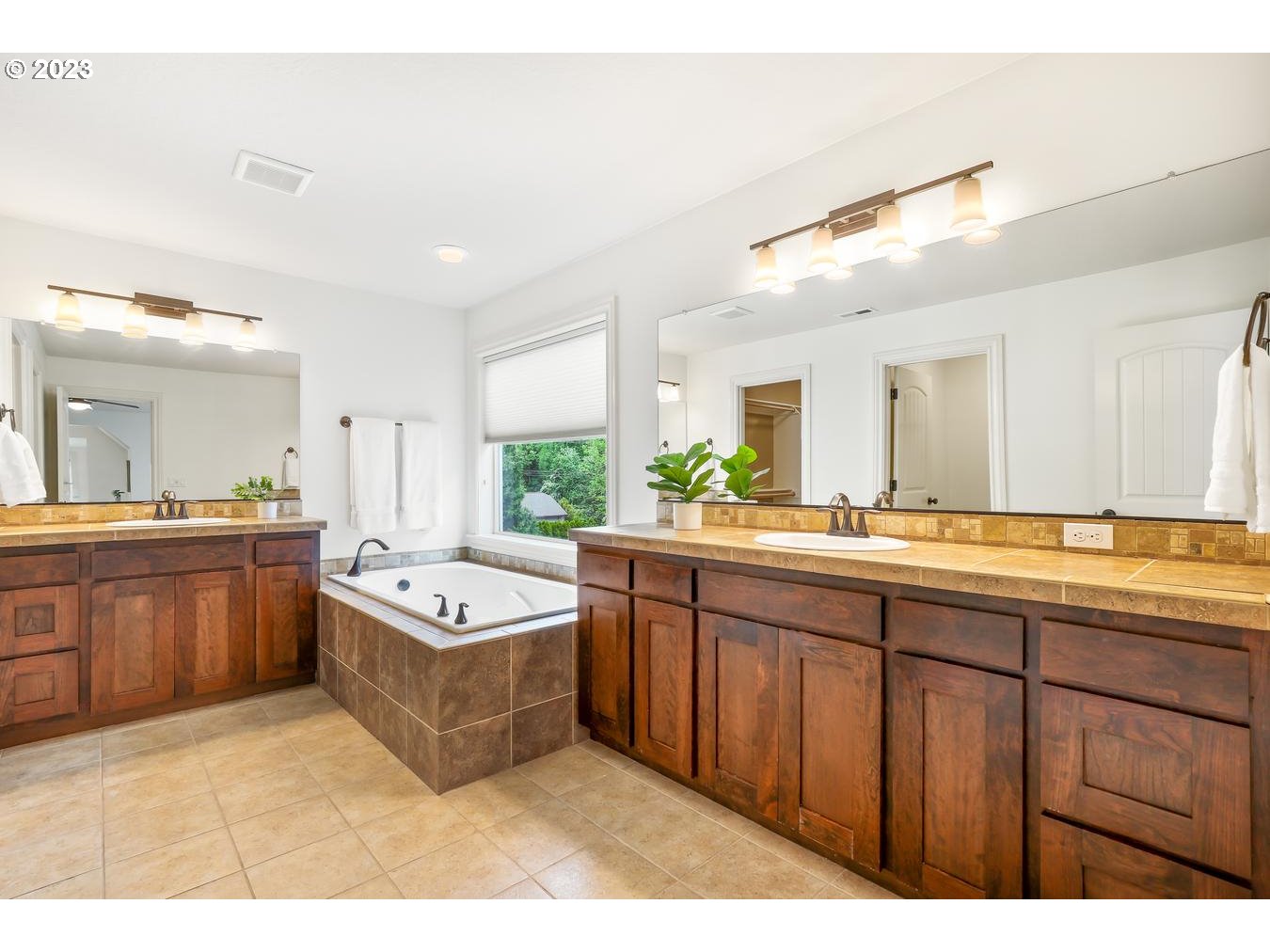 9277 Southwest Rambler Lane Portland, OR 97223 - Photo 27 of 38 a spacious bathroom with a tub sink and mirror