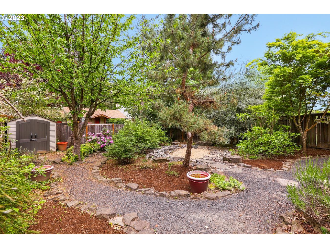 9277 Southwest Rambler Lane Portland, OR 97223 - Photo 31 of 38 a view of a garden with a fountain