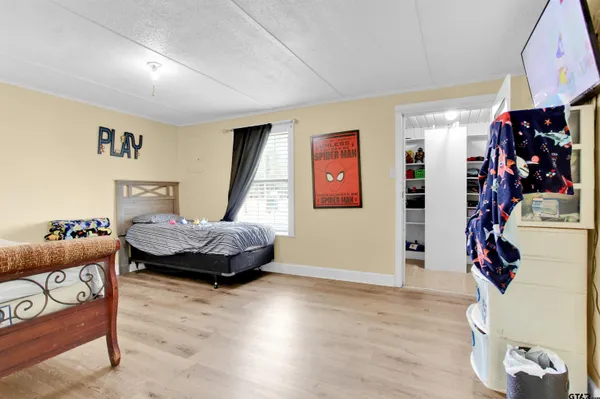 a bedroom with furniture and wooden floor