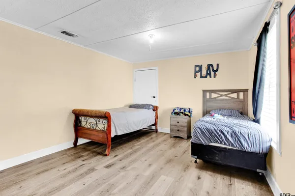 a bedroom with a bed and a night stand