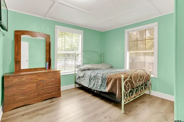 a bed sitting in a bedroom next to a window