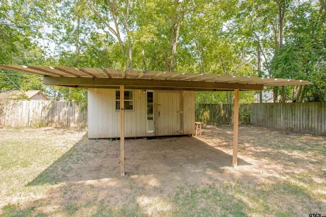 a backyard of a house with a tree