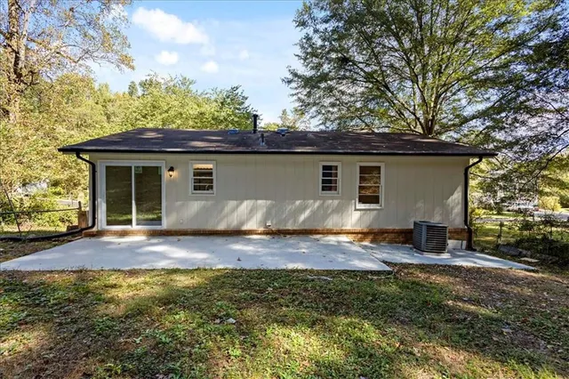 a view of house with backyard space and balcony