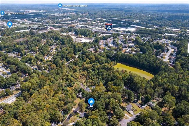 an aerial view of residential house with green space and mountain view