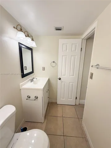 a bathroom with a sink toilet and mirror