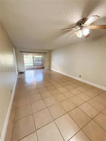 a view of a livingroom and a chandelier fan