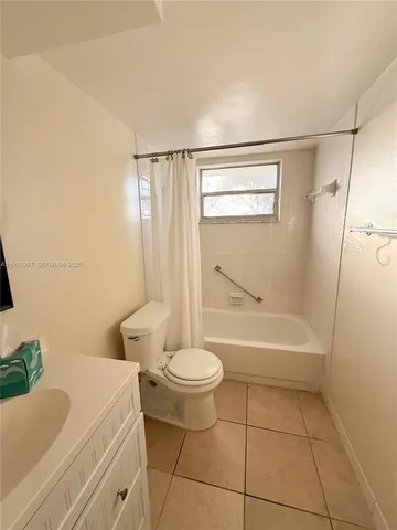 a bathroom with a bathtub and a toilet
