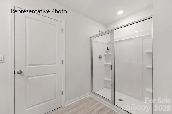 a bathroom with a glass shower door