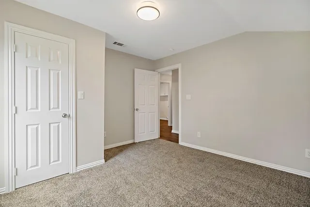 an empty room with closet area