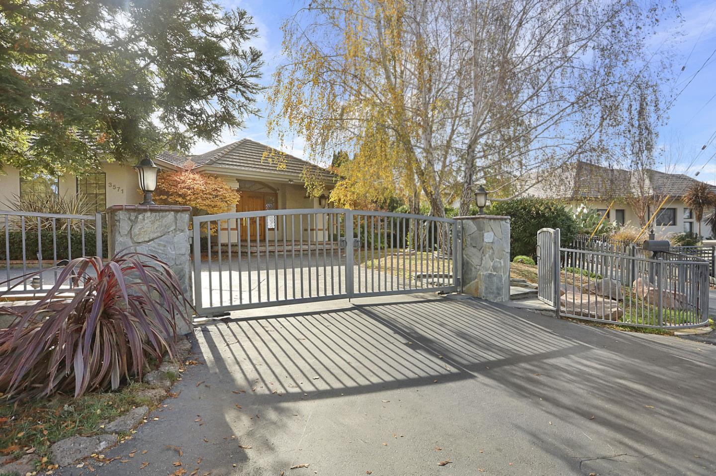 3571 Star Ridge Road Hayward, CA 94542 - Photo 6 of 66 a view of a brick house with large trees and wooden fence