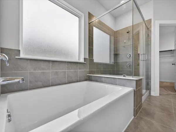 a bathroom with a bathtub and shower